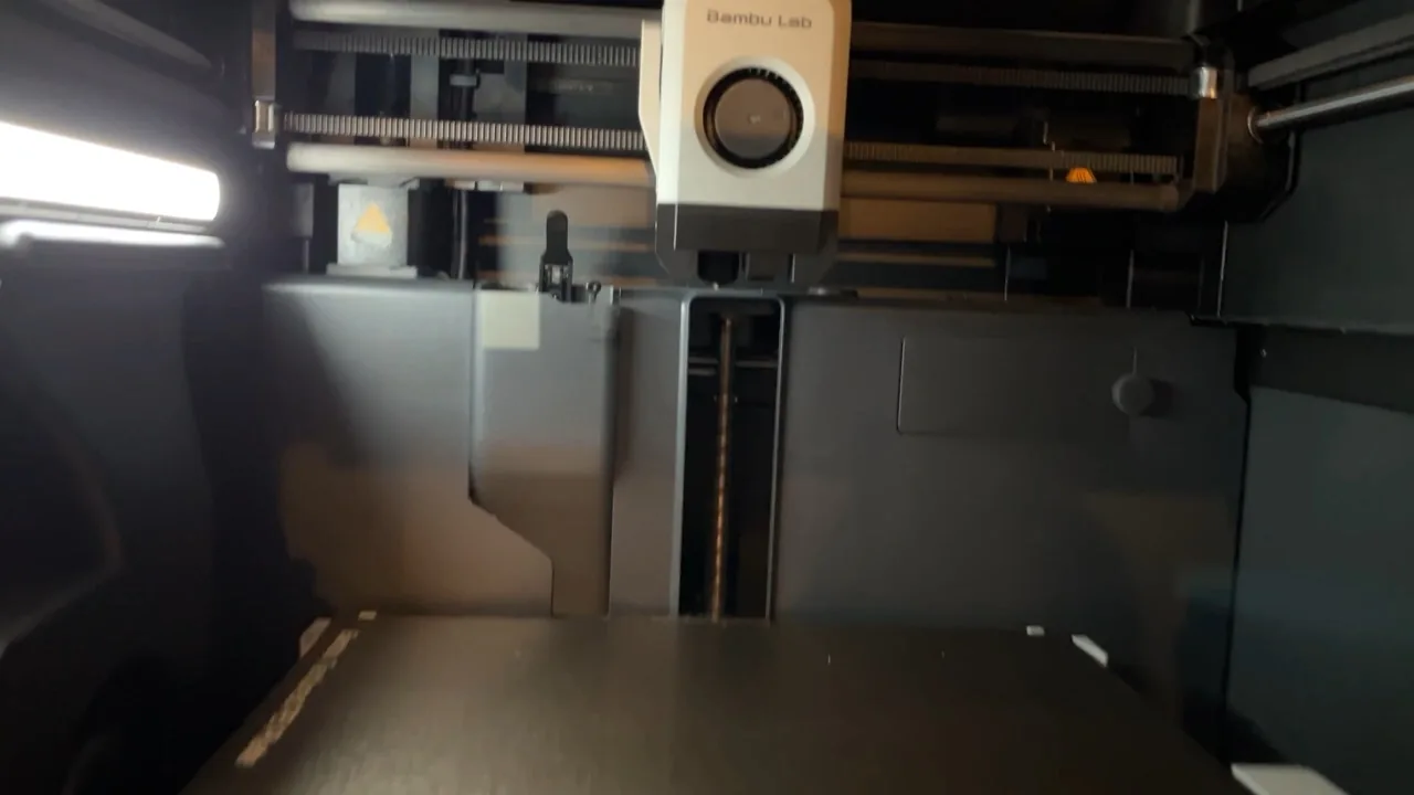 Bambu Lab P1S printing inside its enclosed build chamber
