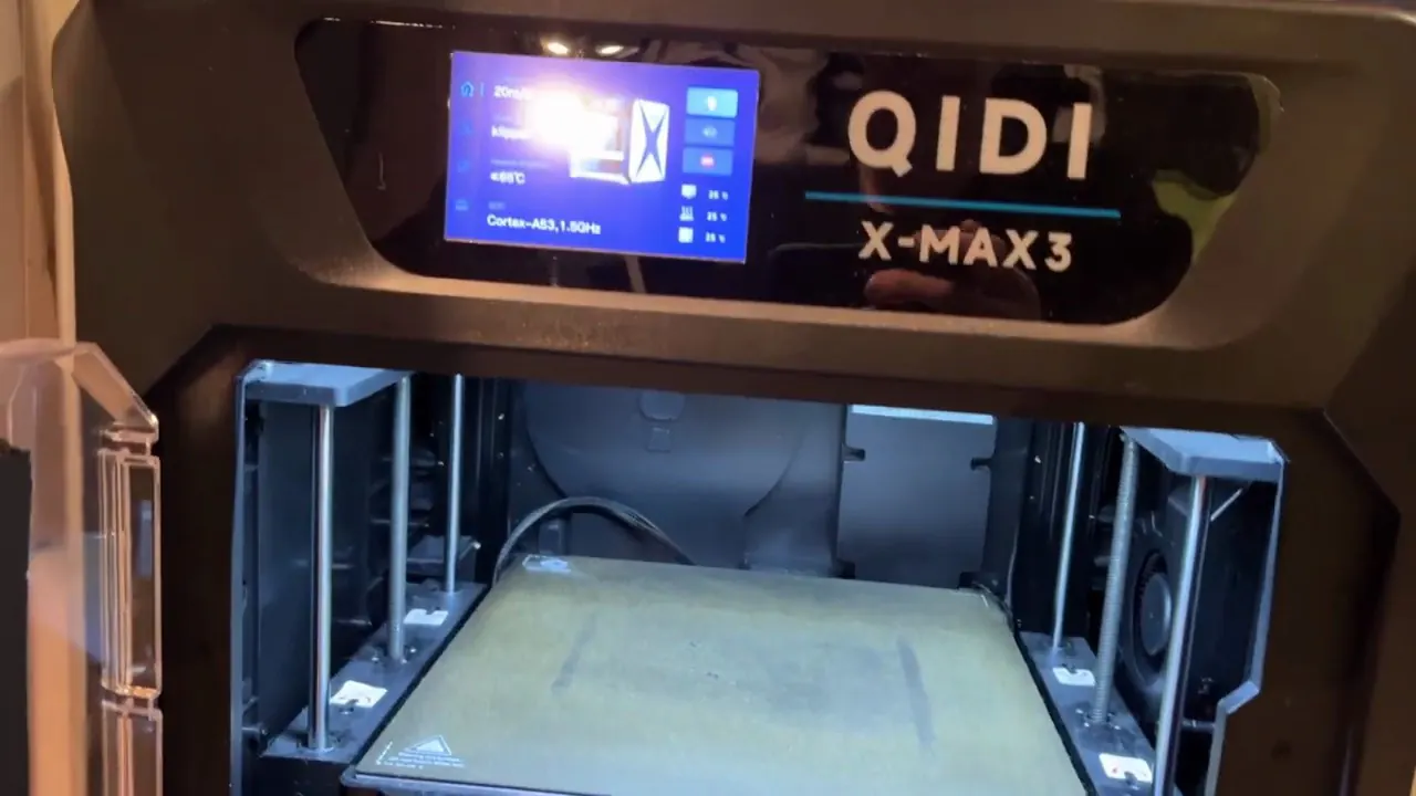QIDI X-Max 3 with its front door open, showing the large enclosed build chamber